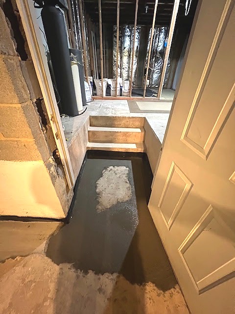 Waterproofing and drainage work around a stepped basement entry