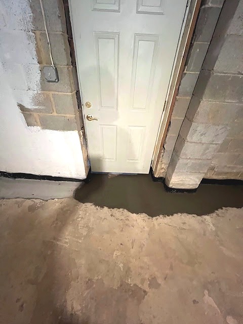 Waterproofing work around a basement entry where water had been reaching the floor